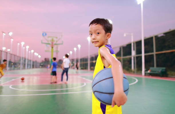 Cute little boy playing basketball