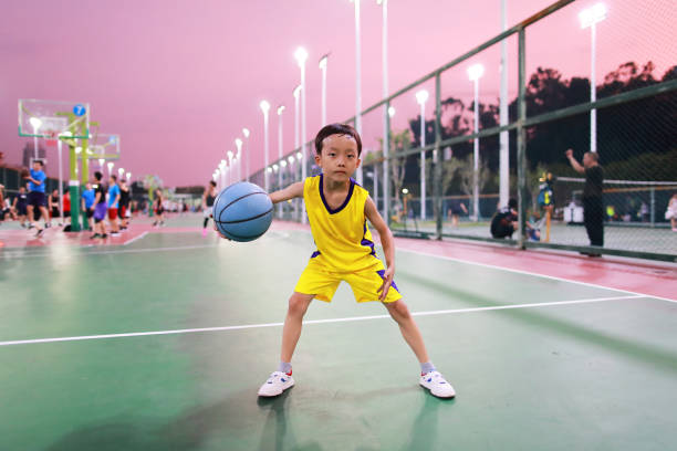 istock Cute little boy playing basketball 1169928024