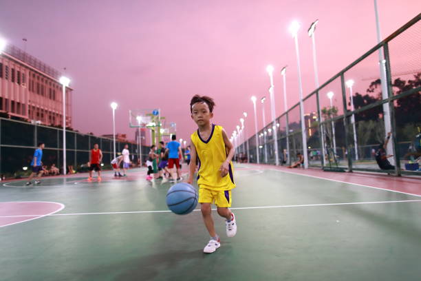 Cute little boy playing basketball