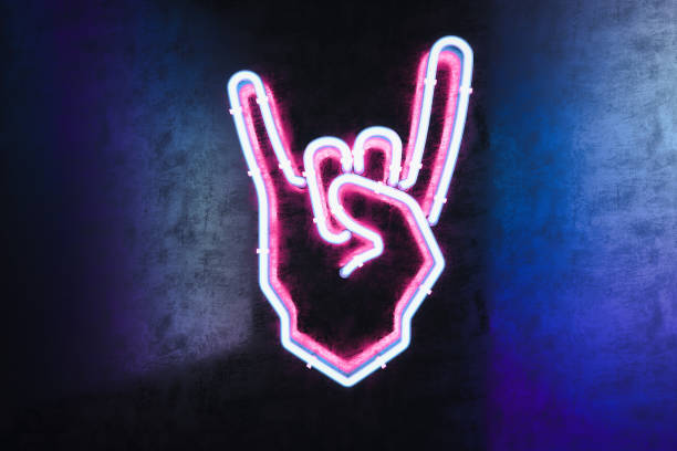 istock Hand in rock and roll sign made from neon lamps on dark background. 3d rendering. 1169928772