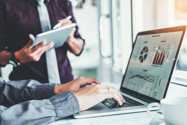 Co-working Business Team Consulting meeting Planning with digital tablet Strategy Analysis investment and saving concept. meeting discussing new plan financial graph data.