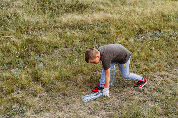 istock the child collects plastic garbage in the forest in the summer 1169930482