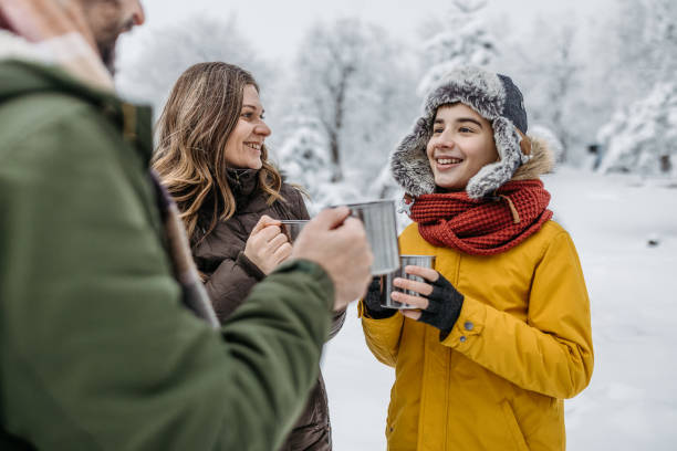 istock Family drinking tea outdoors on a winter road trip 1169932031