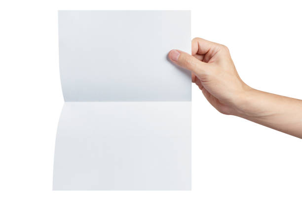 istock Hand holding a sheet of white paper on white 1169932230