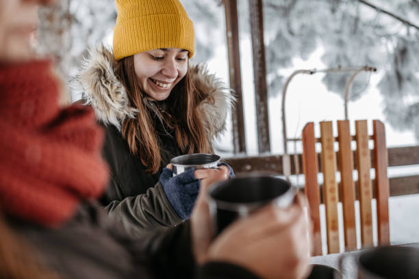 istock Mother with her daughter drinking hot tea outdoors 1169932934