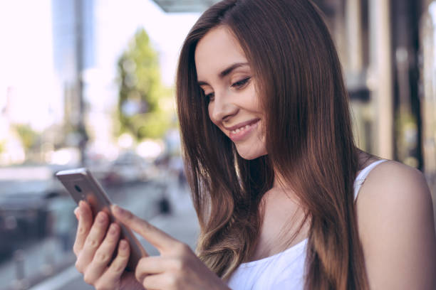 istock Telephone cellular user student lady business work model concept. Profile side close up view photo portrait of beautiful glad nice excited pretty teenager looking at picture she got from friend 1169932954