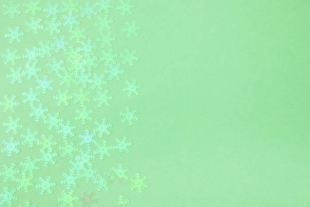istock holographic foil snowflakes confetti sparse on trendy mint colored background 1169939532