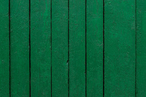 Peeling Green Painted Old Wooden Fence Background stock photo