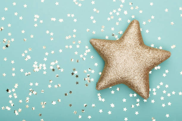 istock Christmas composition. Christmas golden glittering decorations on color background. Flat lay, top view, copy space - Image 1169943068