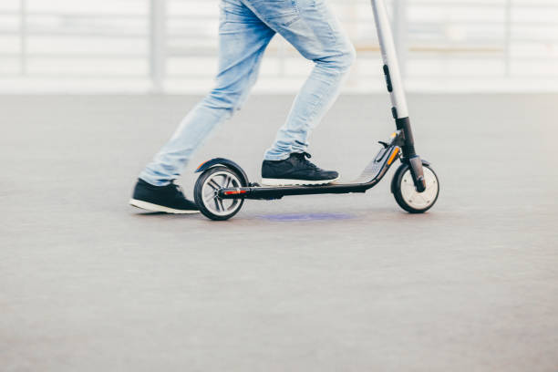 istock Unrecognizable man has active lifestyle, rides electric scooter, has hobby, rests as has weekend. People, hobby and driving concept 1169943382