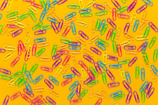 istock Paper color clip notebook on yellow background. Flat lay. 1169943628