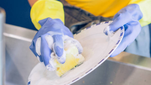 istock Young girl scrubbing a plate 1169944716