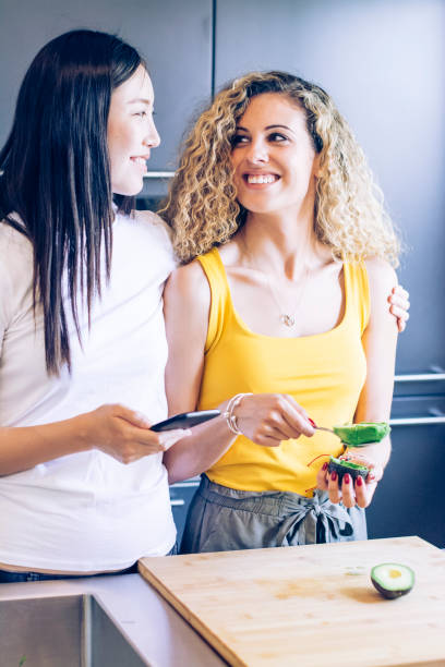 istock Girls having fun in kitchen wile preparing avocado 1169945554