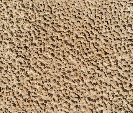 seamless texture - gray rough dried clay with traces of raindrops