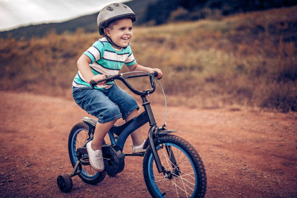 istock Kid playing with his bike 1169951961