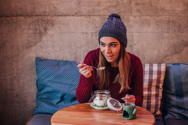 istock Woman eating muesli and yogurt 1169953099