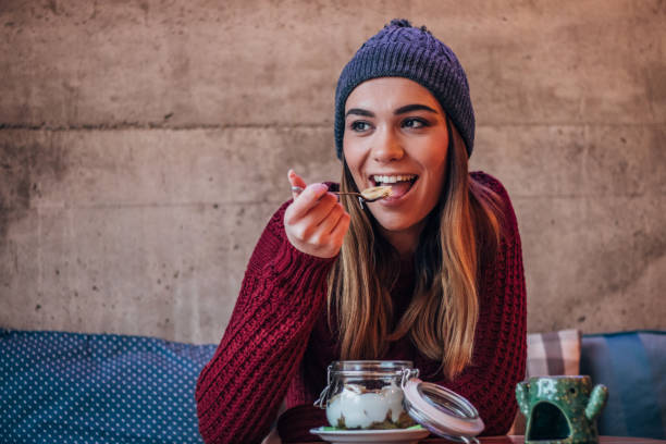 istock Pretty woman eating muesli and yogurt 1169953155