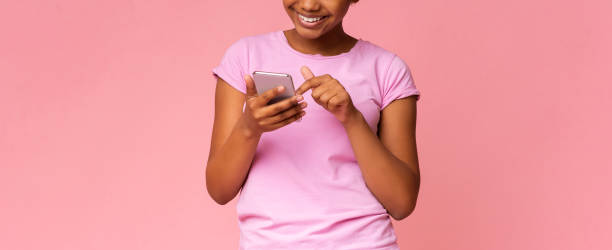 istock Excited black teen browsing media on smartphone 1169953329