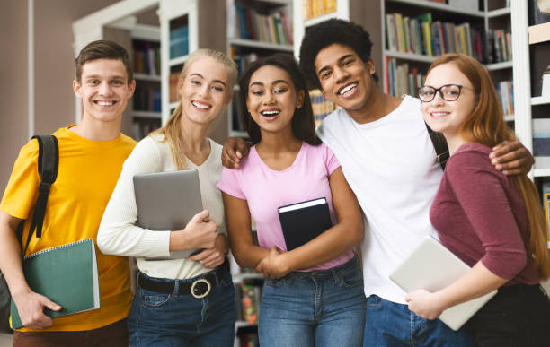 istock Group of students studying in library at university 1169954299