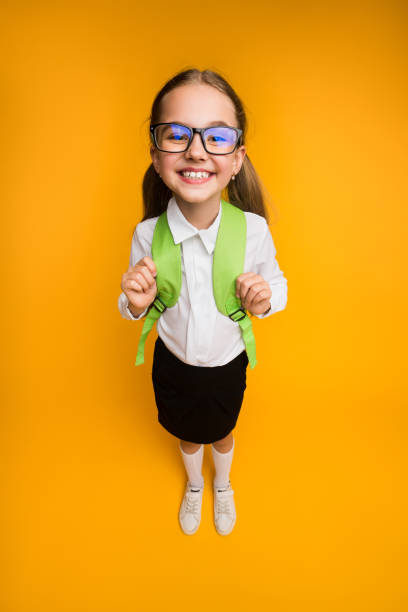 istock Happy Elementary School Girl In Eyewear Smiling At Camera High-Angle 1169954468