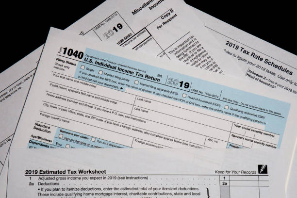 2019 US/IRS tax forms lay on a desktop 2019 US tax forms lay on a desktop in West Des Moines, Iowa. 2019 stock pictures, royalty-free photos & images