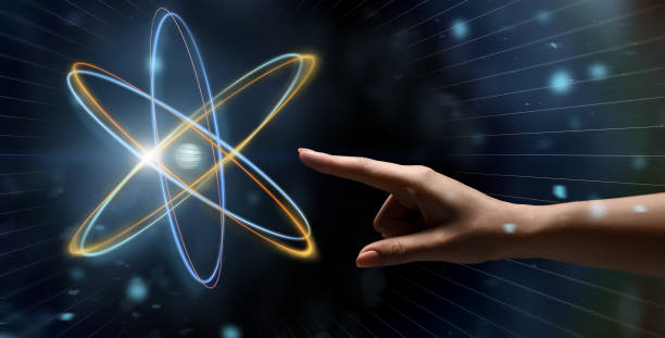 istock Female hand reaching to glowing atom projection 1169954722