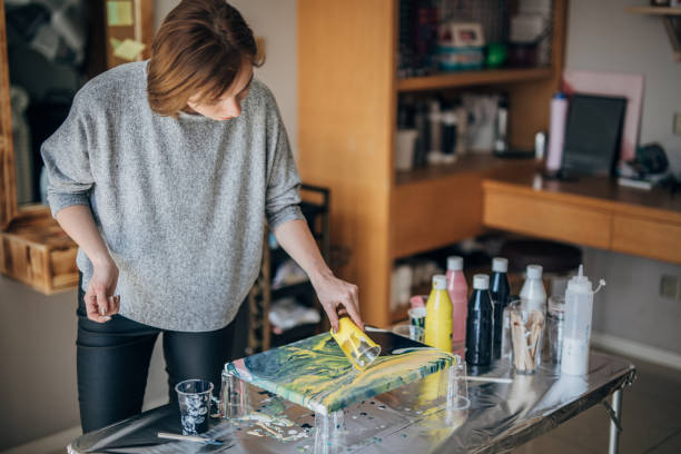 istock Female artist painting 1169954822
