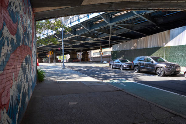 Dumbo Brooklyn, NY, USA - August 24, 2019: Down Under the Manhattan Bridge  (Dumbo)is quiet early on a Sunday morning with only the sound of subways and traffic on the bridge audible from the ground. warren street brooklyn stock pictures, royalty-free photos & images