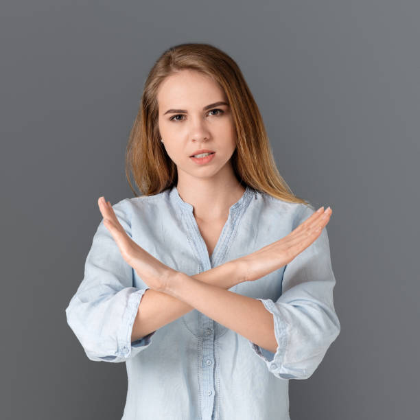 istock Woman showing stop sign with her hands crossed 1169956520