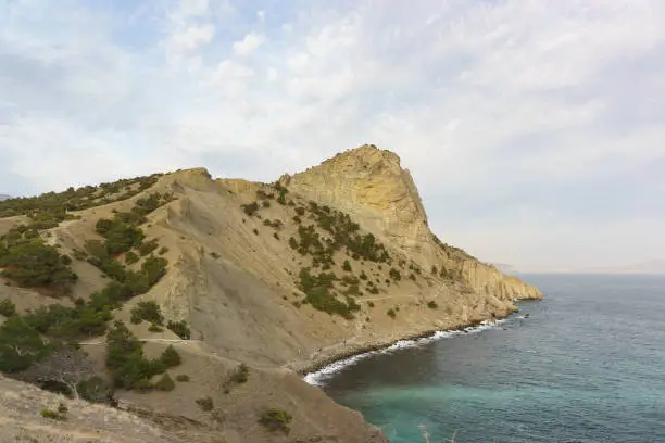 Photo of landscape view of the cave mountain Koba-Kaya and the popular route Golitsyn trail in the Crimea. Early spring