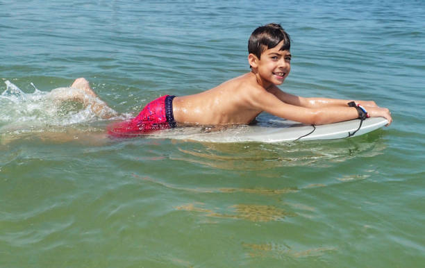 istock Ten year old boy  floating on a surf board at South Bethany Beach Delaware 1169956784