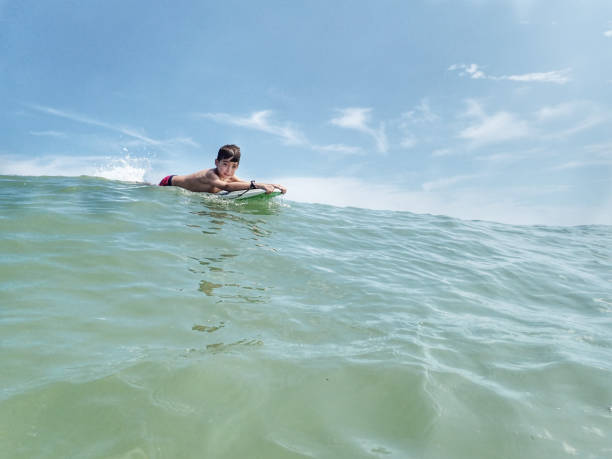 istock Ten year old boy  floating on a surf board at South Bethany Beach Delaware 1169956820