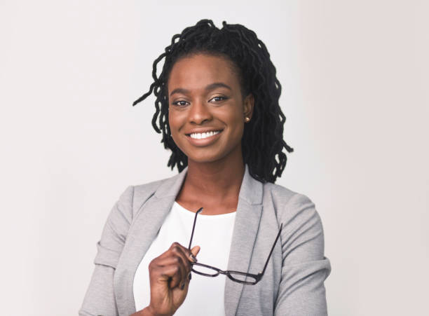 istock Business Lady Smiling At Camera Holding Eye Glasses On White 1169956833