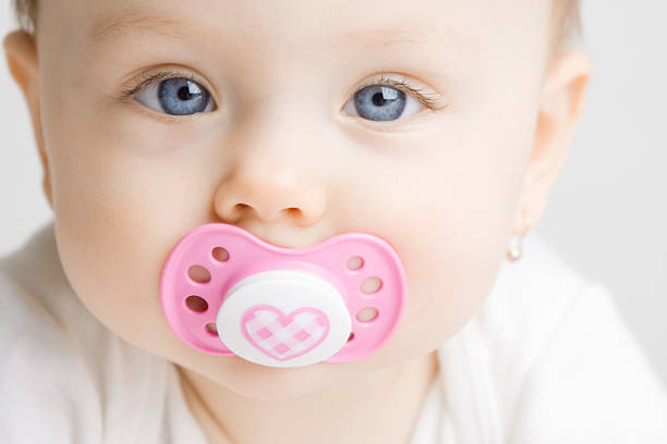 Baby with soother stock photo