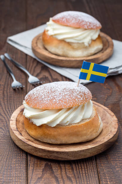 istock Traditional swedish dessert Semla, also called Shrove bun, with almond paste and whipped cream filling,  vertical 1169962917