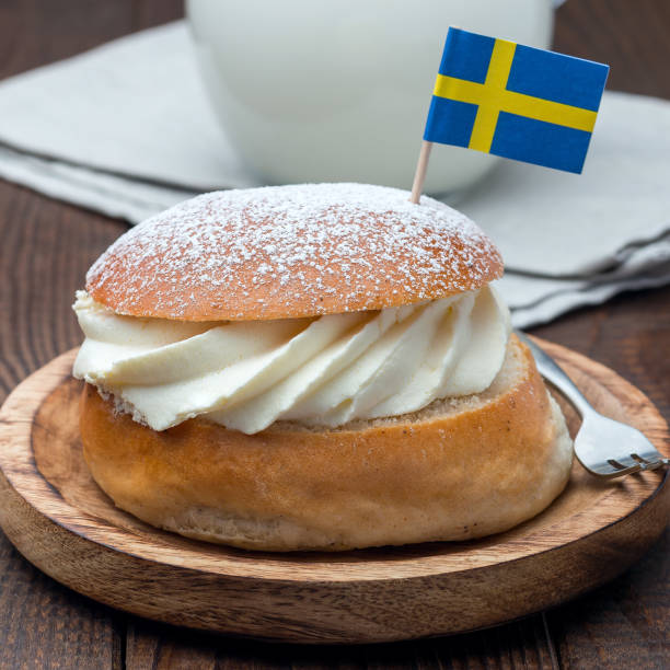 istock Traditional swedish dessert Semla, also called Shrove bun, with almond paste and whipped cream filling, served with milk,  square format 1169962934