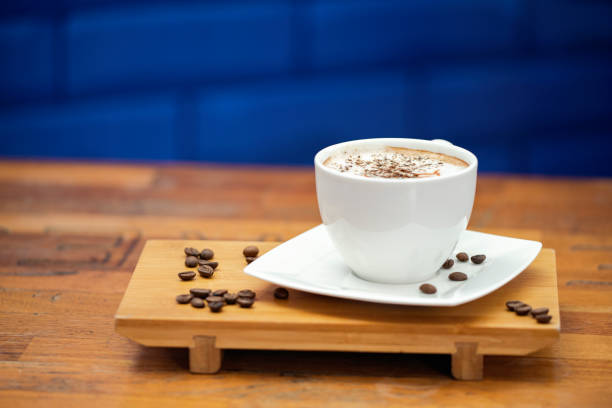 istock Coffee cup and coffee beans on wood. 1169965284
