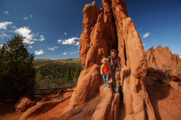 istock Mom and her son climbing rocks 1169968518