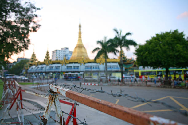 Yangon, Myanmar -  November 2018 Fencing protects the roundabout in front of the Sule Pagoda in downtown Yangon sule pagoda stock pictures, royalty-free photos & images