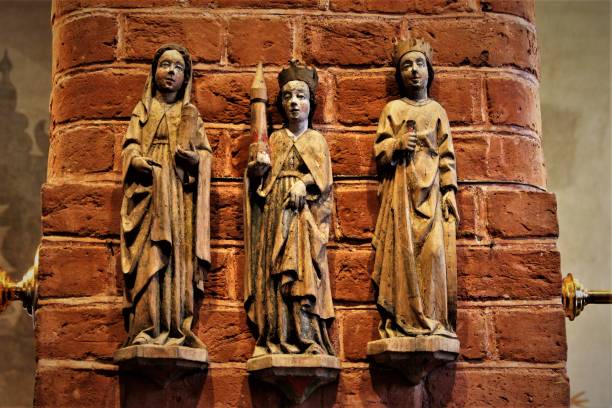 Jesus Christ with some of the saints depicted on the reredos in the Minster church of St Margaret, King’s Lynn, in Norfolk, Eastern England. The saints seen here are St Jerome, St Gregory, St Augustine and St Ambrose and, creepily, all the figures appear to be looking straight at the viewer. The reredos was designed and installed by GF Bodley in 1899 during renovation by Sir George Gilbert Scott. The church dates from 1101AD and was founded by Herbert de Losinga, Bishop of Norwich.