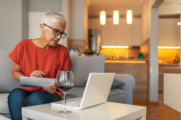 istock Senior woman checking bills 1169975969
