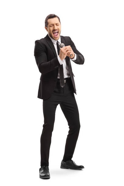 istock Male singer with a microphone singing and enjoying 1169975978