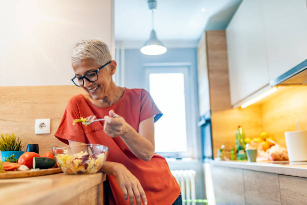istock Mature Woman Having Salad  For lunch 1169976564