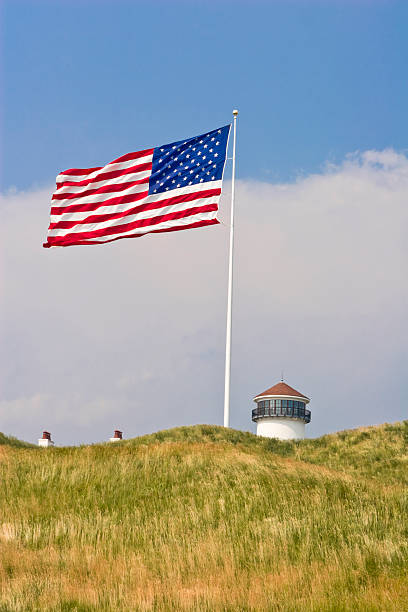istock American Flag with Top of Lighthouse, Before a Summer Storm. 116997780