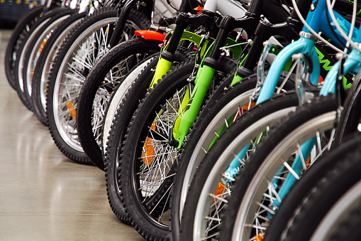 Many bicycles in sports store parked in a row, seasonal sale shopping concept