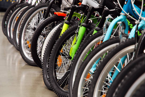 Many bicycles in sports store, seasonal sale Many bicycles in sports store parked in a row, seasonal sale shopping concept bicycle shop stock pictures, royalty-free photos & images