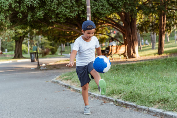 istock Boy play with football ball 1169980233