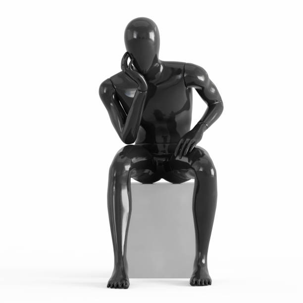 istock A black mannequin sits on a white box leaning on his arm.rendering on a white background 1169981967
