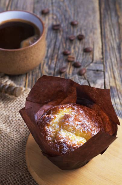 istock Muffin in wax paper and coffee 1169982251