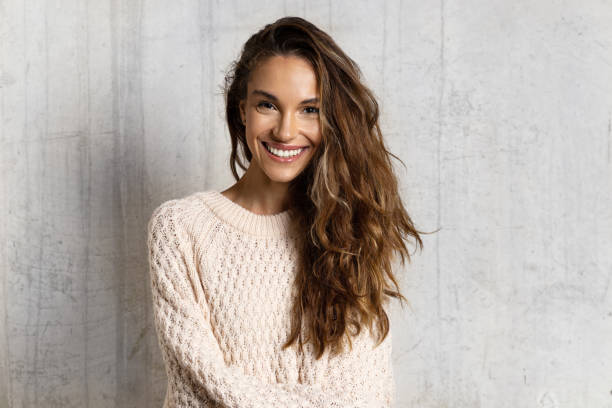 улыбающаяся молодая женщина чувствует себя счастливой - brown hair стоковые фото и изображения
